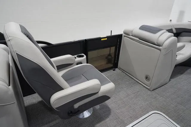 Slide: The Image of 2025 Barletta Boats C22QC interior with gray seating and carpeted flooring. - 29