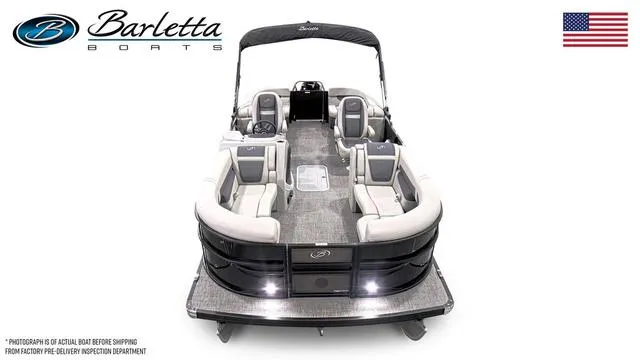 Slide: The Image of 2025 Barletta Boats C22QC pontoon with luxurious seating and sleek design, featuring American flag. - 43