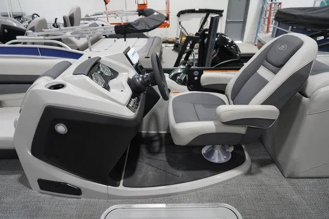 Slide: The Image of 2025 Barletta Boats C22QC helm with modern controls and comfortable captain's chair. - 8