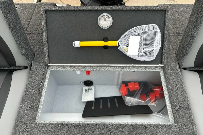 Slide: The Image of Storage compartment of 2026 Lund 1975 Tyee boat with fishing net and accessories. - 13