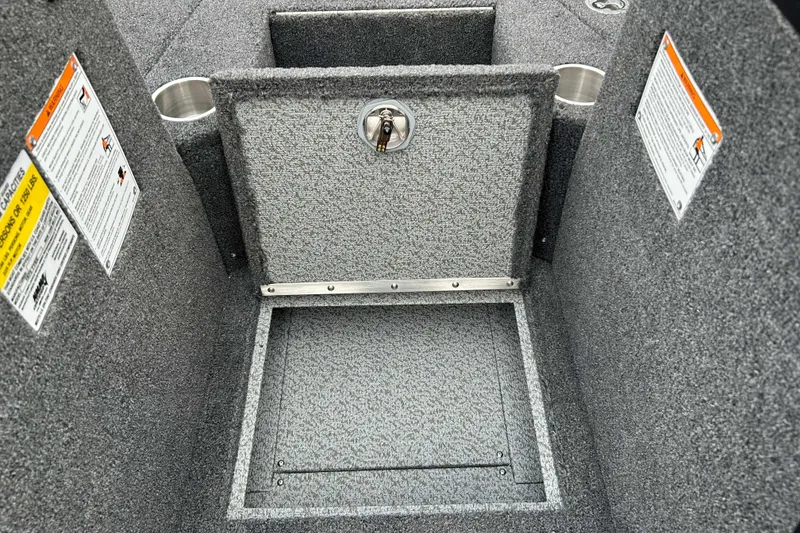 Slide: The Image of Interior of 2026 Lund 1975 Tyee boat with storage compartment and safety labels. - 15