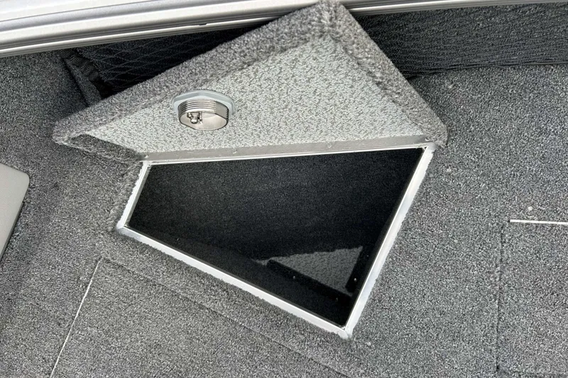 Slide: The Image of Open storage compartment in 2026 Lund 1975 Tyee boat, featuring carpeted interior. - 17