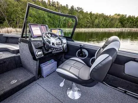 Slide: The Image of Interior of 2026 Lund 1975 Tyee boat with steering wheel and seating. - 6