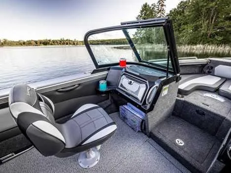 Slide: The Image of Interior view of 2026 Lund 1975 Tyee boat, featuring steering wheel and dashboard controls. - 8