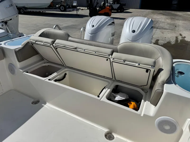 Slide: The Image of 2024 Key West 263 FS boat with open storage compartments and dual outboard motors. - 11