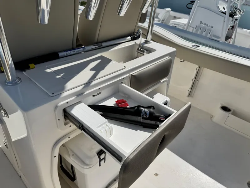 Slide: The Image of 2024 Key West 263 FS boat interior with open storage drawer and fishing gear. - 15