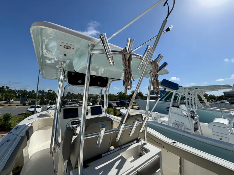 Slide: The Image of 2024 Key West 263 FS boat with fishing rod holders and modern dashboard. - 16