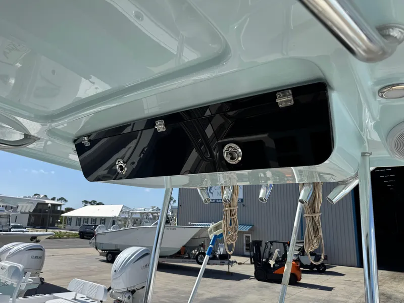 Slide: The Image of 2024 Key West 263 FS boat with overhead storage compartment and visible dockside view. - 22