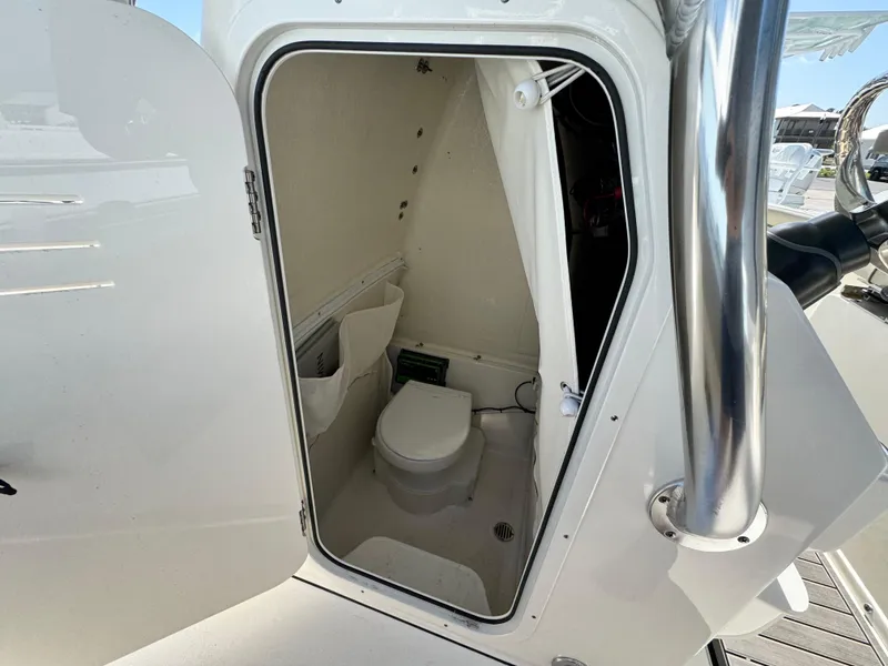 Slide: The Image of 2024 Key West 263 FS boat interior with compact marine toilet. - 23