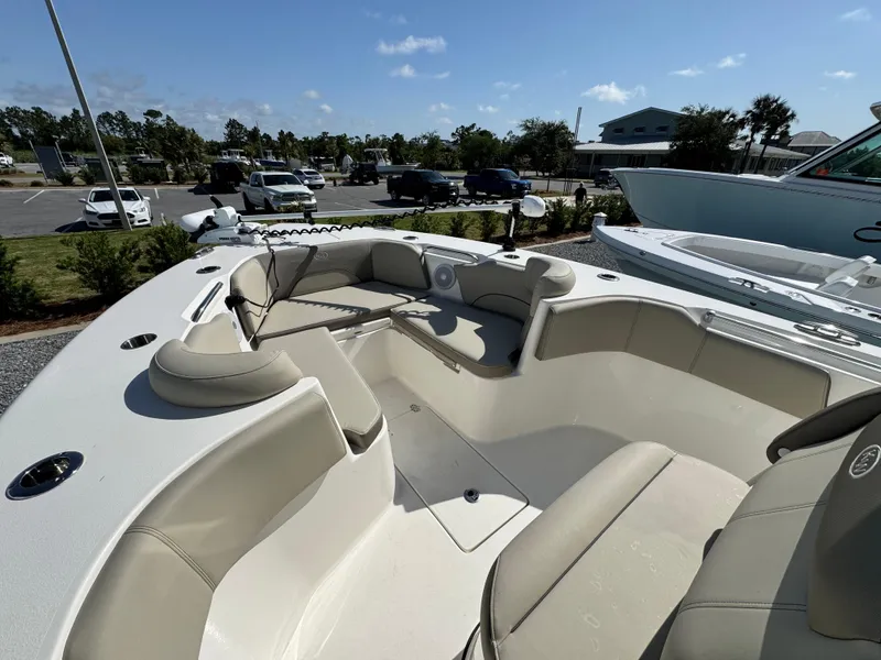 Slide: The Image of 2024 Key West 263 FS boat with spacious seating in a marina setting. - 25