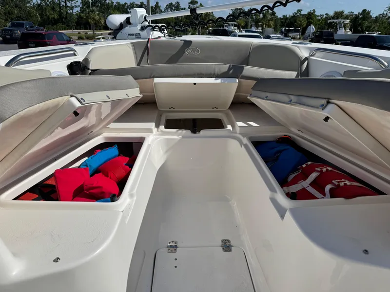 Slide: The Image of 2024 Key West 263 FS boat interior with open storage compartments and life jackets. - 29