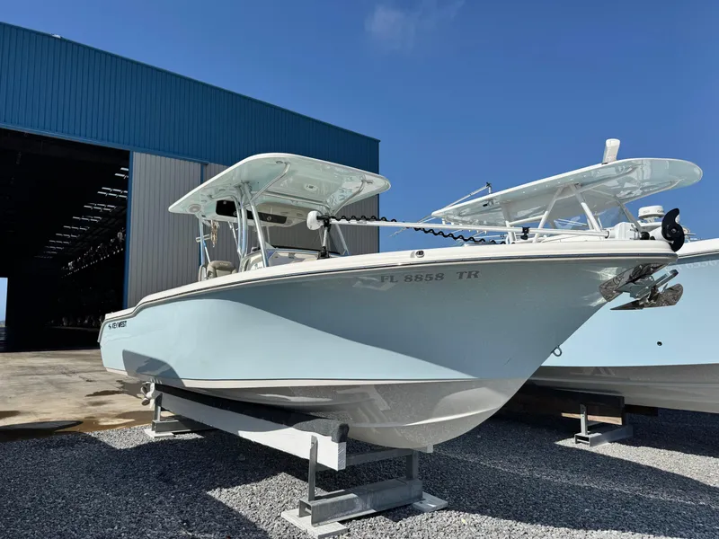 Slide: The Image of 2024 Key West 263 FS boat on display outside a blue warehouse. - 3
