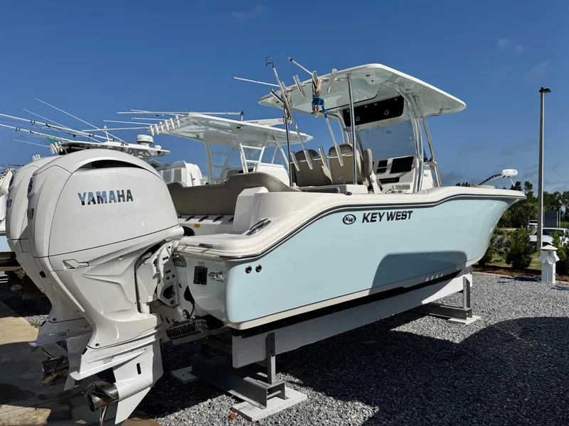 Slide: The Image of 2024 Key West 263 FS boat with Yamaha engine, displayed outdoors on gravel. - 4