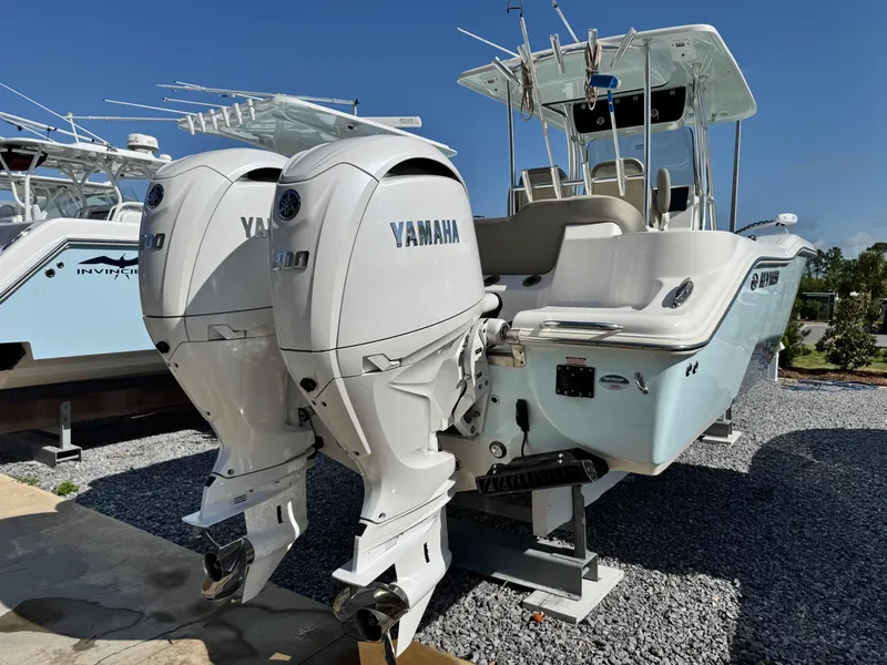 Slide: The Image of 2024 Key West 263 FS boat with dual Yamaha engines, displayed outdoors. - 5