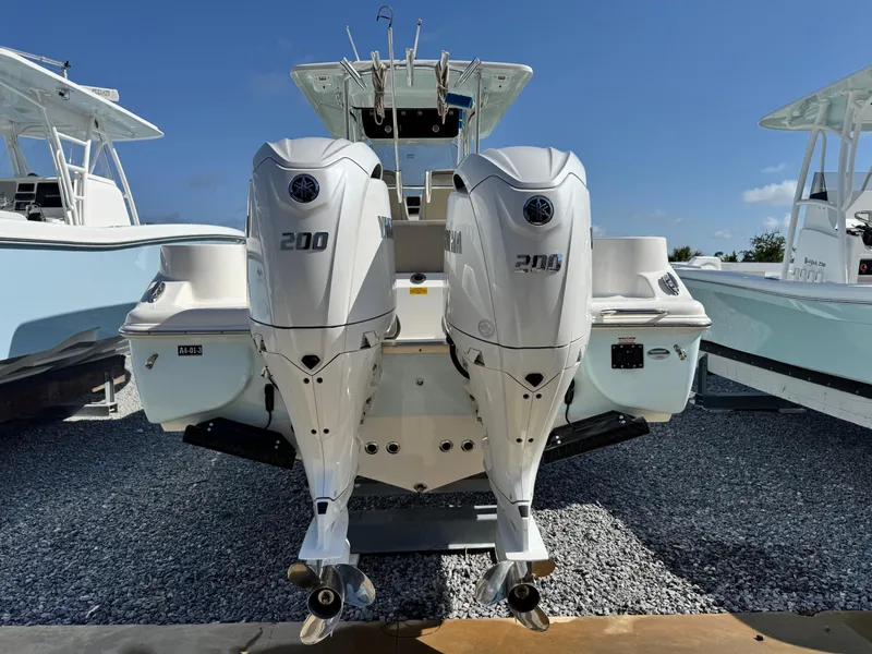 Slide: The Image of 2024 Key West 263 FS boat with dual 200 horsepower engines, displayed on gravel. - 6