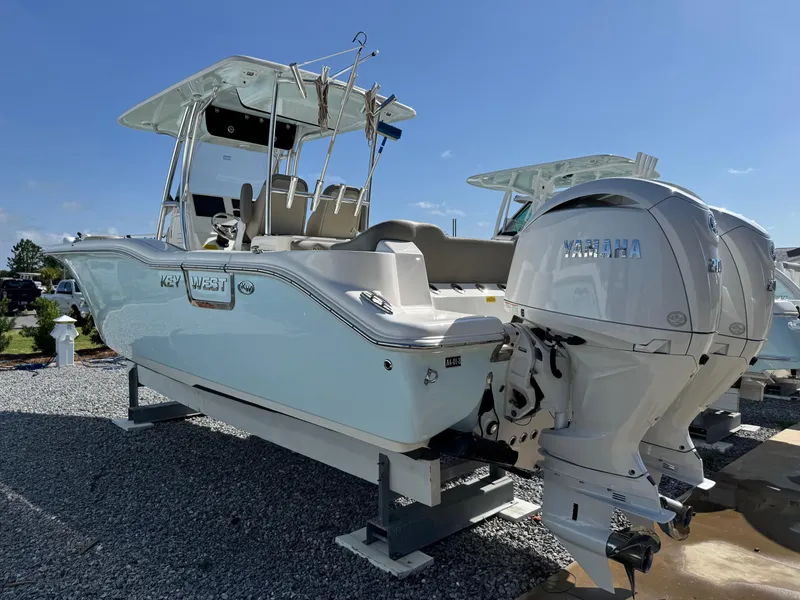 Slide: The Image of 2024 Key West 263 FS boat with dual engines on display outdoors. - 7