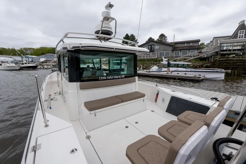 Slide: The Image of 2019 Axopar 37 Cabin boat docked, featuring spacious seating and modern design. - 11