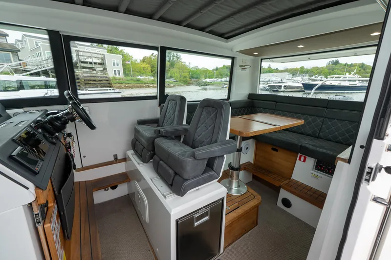 Slide: The Image of Interior of 2019 Axopar 37 Cabin with seating and table, showcasing modern design. - 14