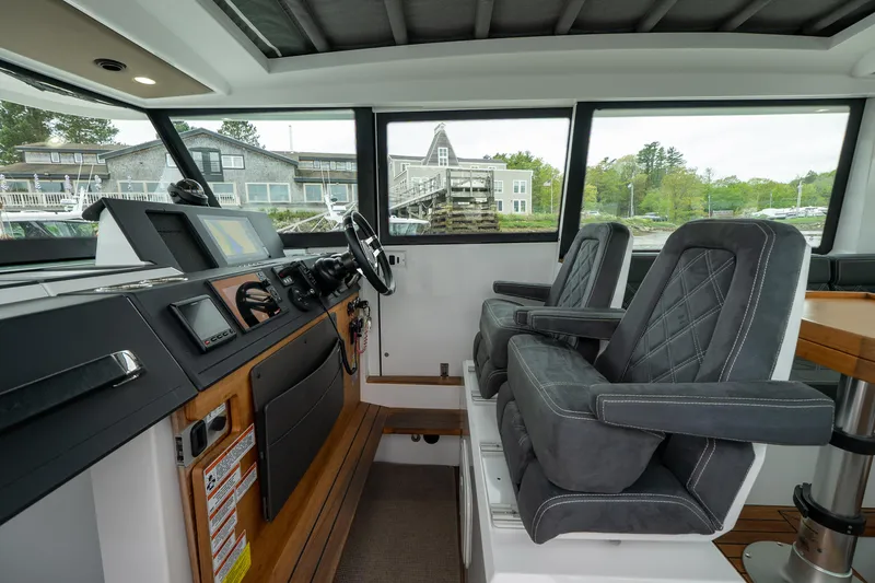 Slide: The Image of Interior of 2019 Axopar 37 Cabin boat with modern dashboard and comfortable seating. - 15