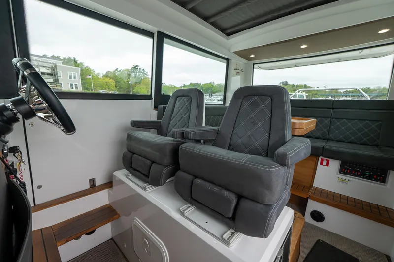 Slide: The Image of 2019 Axopar 37 Cabin interior with plush seating and modern design. - 16