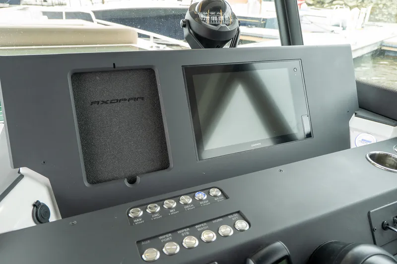 Slide: The Image of Control panel of 2019 Axopar 37 Cabin boat with touchscreen and compass. - 19