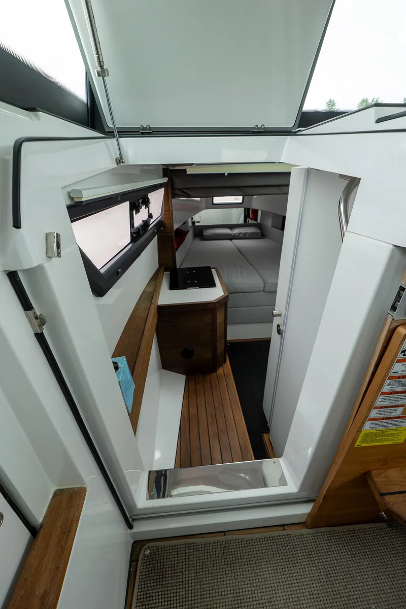 Slide: The Image of Interior view of 2019 Axopar 37 Cabin with modern design and wood accents. - 24