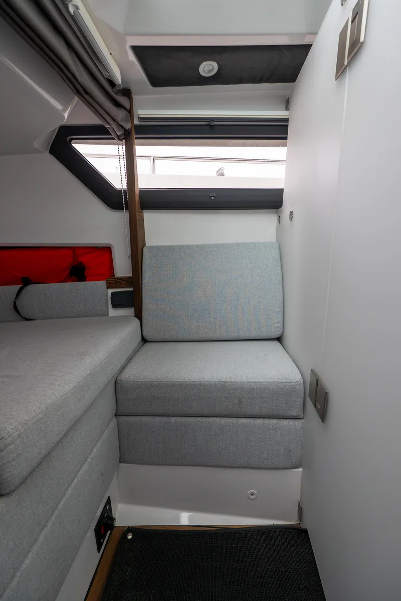 Slide: The Image of 2019 Axopar 37 Cabin interior with gray seating and modern design. - 27