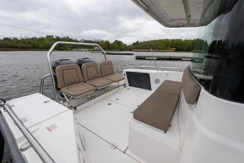 Slide: The Image of 2019 Axopar 37 Cabin boat with spacious seating on a calm lake. - 9