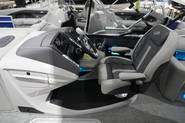 Slide: The Image of 2025 Barletta Boats L23M helm with modern steering and comfortable seating. - 10