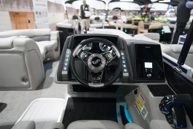 Slide: The Image of 2025 Barletta Boats L23M dashboard with modern steering wheel and control panel. - 12