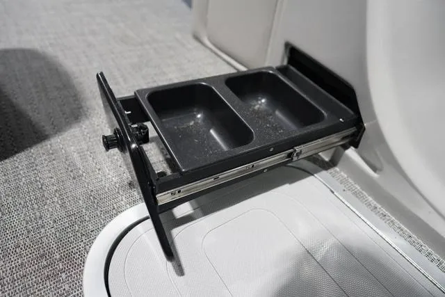 Slide: The Image of Pull-out storage tray on 2025 Barletta Boats L23M, featuring dual compartments. - 19