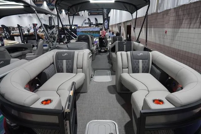 Slide: The Image of 2025 Barletta Boats L23M pontoon with luxurious seating and modern design in showroom. - 2