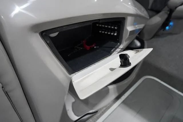 Slide: The Image of 2025 Barletta Boats L23M interior storage compartment with open lid and visible wiring. - 20