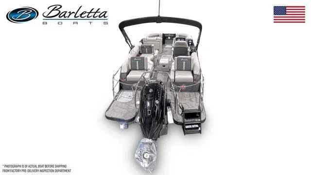 Slide: The Image of 2025 Barletta L23M pontoon boat, luxury seating, sleek design, outboard motor, American flag. - 46