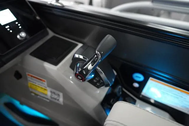 Slide: The Image of Control panel of 2025 Barletta Boats L23M with illuminated displays and throttle lever. - 7