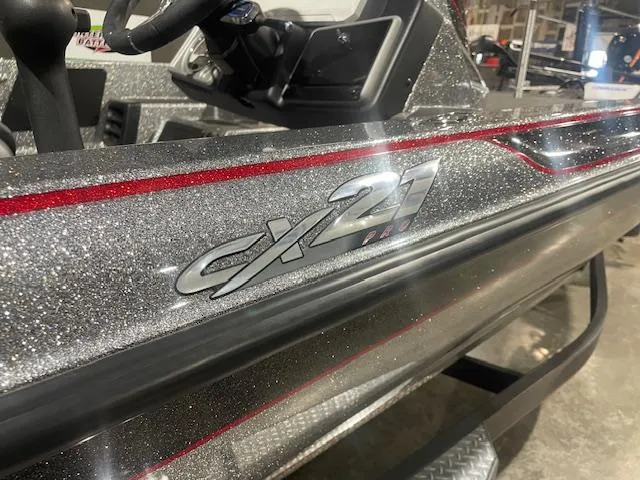Slide: The Image of 2023 Caymas CX21Pro boat with metallic finish and red accents. - 4