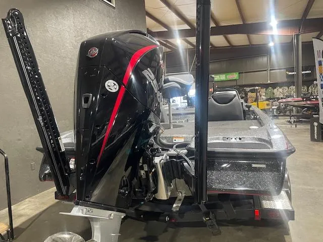 Slide: The Image of 2023 Caymas CX21Pro boat in showroom, rear view with powerful engine. - 5