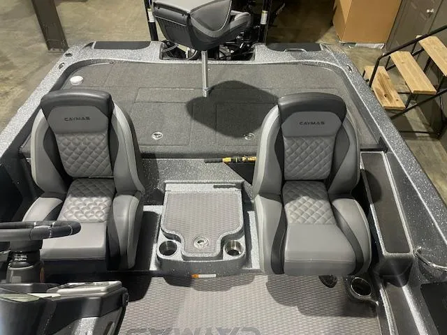 Slide: The Image of 2023 Caymas CX21Pro boat interior with two gray seats and steering console. - 6