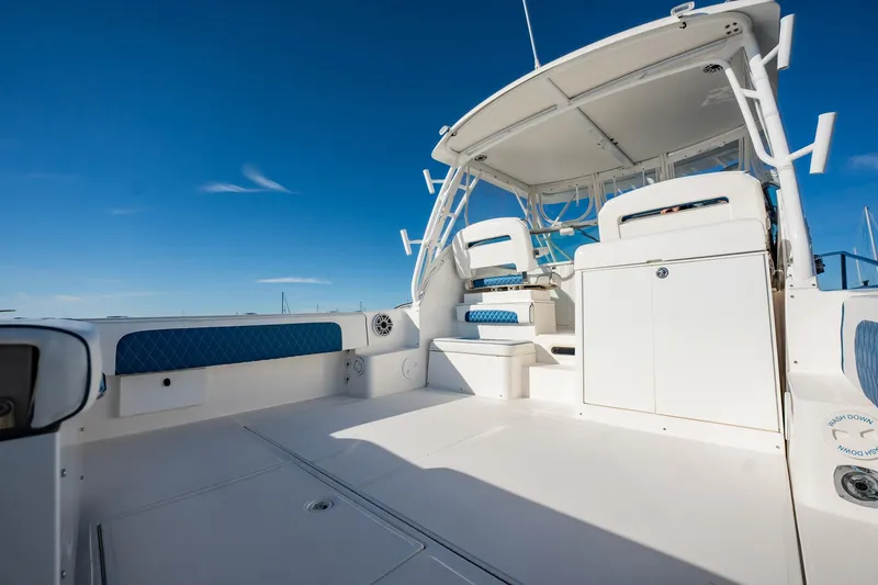 Slide: The Image of 2015 Stamas 390 Aegean boat interior with white seating and blue accents under clear sky. - 10