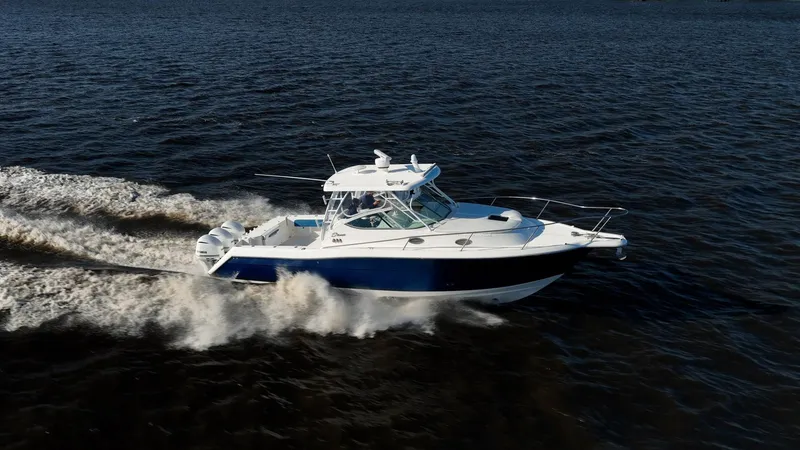 Slide: The Image of 2015 Stamas 390 Aegean boat cruising on open water, creating a dynamic wake. - 14