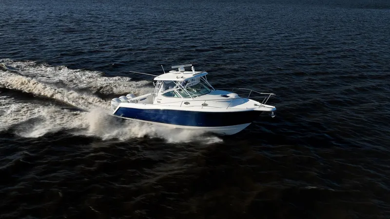 Slide: The Image of Stamas 390 Aegean 2015 boat cruising on open water, creating a wake. - 16