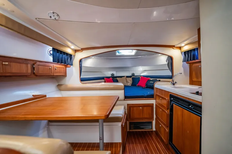 Slide: The Image of 2015 Stamas 390 Aegean yacht interior with wood cabinetry, dining area, and cozy sleeping quarters. - 4