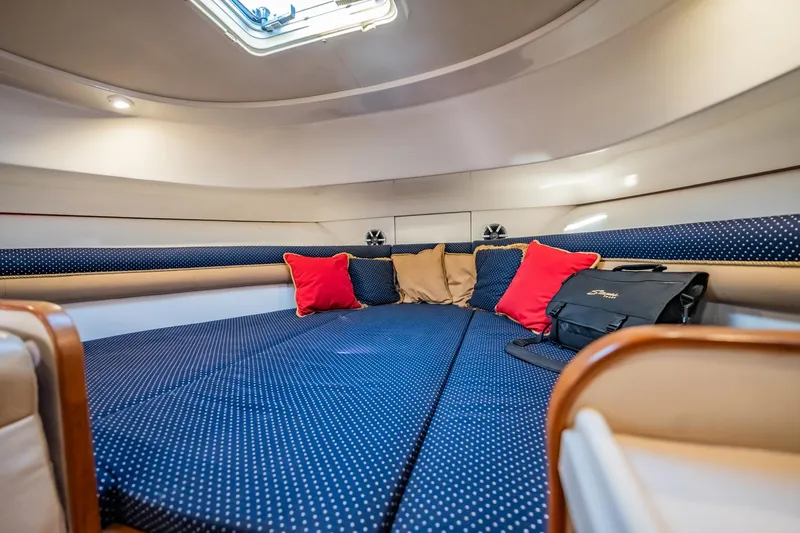 Slide: The Image of 2015 Stamas 390 Aegean cabin interior with blue polka dot bedding and colorful cushions. - 6