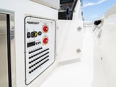 Slide: The Image of Control panel of 2026 Pursuit S 358 boat, featuring switches and dials. - 10
