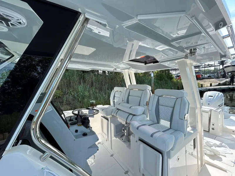 Slide: The Image of 2026 Pursuit S 358 boat interior with luxurious seating and modern helm design. - 12