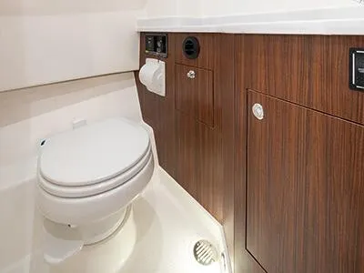 Slide: The Image of 2026 Pursuit S 358 boat bathroom with wood paneling and modern fixtures. - 18