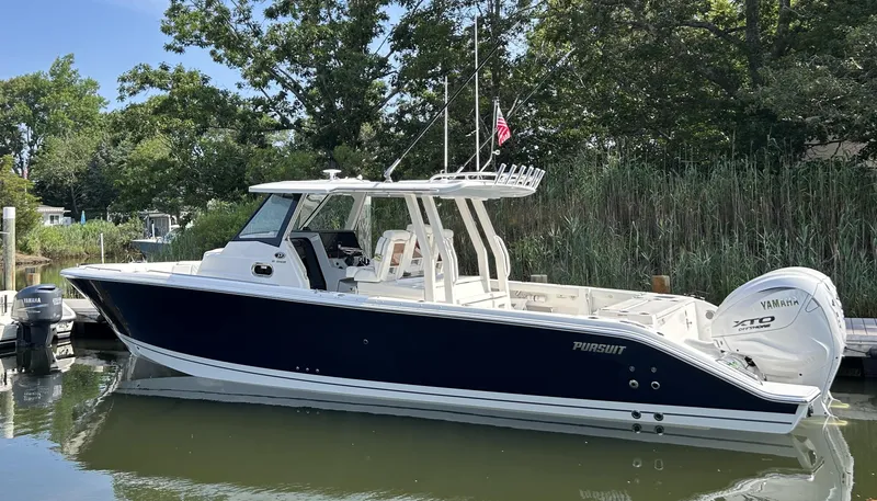 Slide: The Image of 2026 Pursuit S 358 boat docked, featuring sleek design and Yamaha engines. - 2
