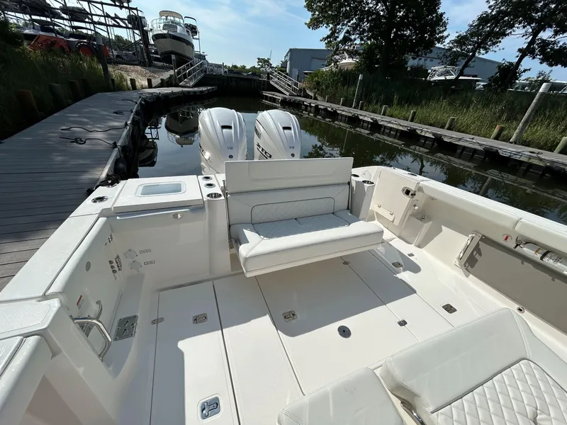 Slide: The Image of 2026 Pursuit S 358 boat with dual engines docked at a marina. - 7