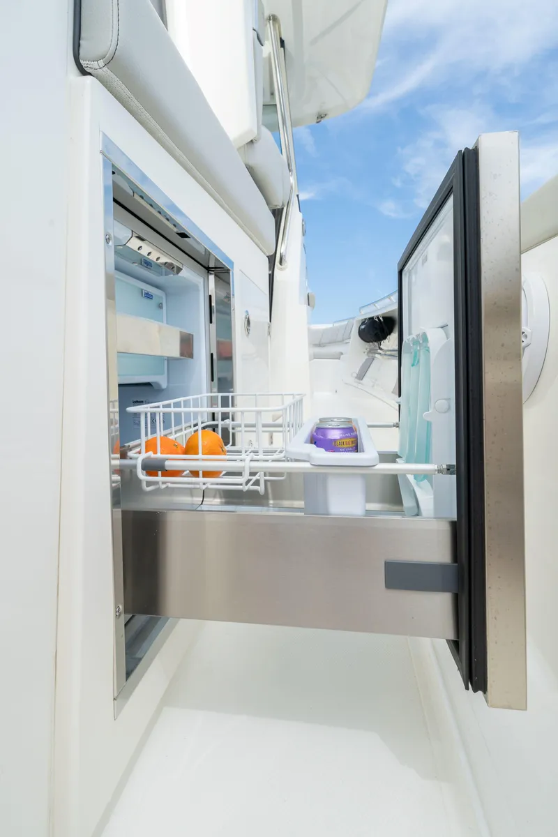 Slide: The Image of Open stainless steel drawer refrigerator on 2026 Pursuit S 358 boat, featuring organized storage. - 8
