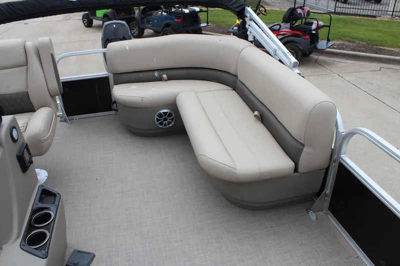 Slide: The Image of 2025 Sun Tracker Party Barge 16 DLX with beige seating and cup holders. - 12